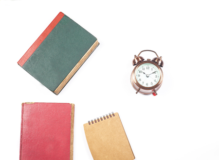 old book and alarm clock on isolate の写真素材