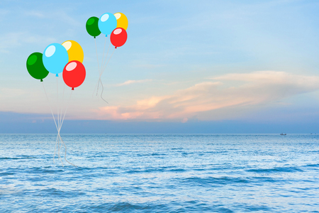 colorful balloon over sea with sun ray background.の写真素材