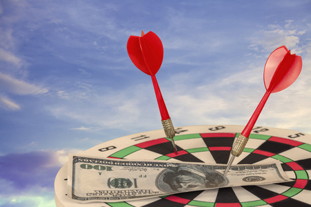 Red Dart Arrow on Target dartboard with Blue Sky background.Business success concept.の写真素材