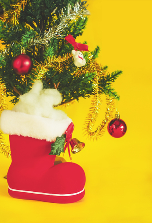 Red Christmas boot with gift on color background.の写真素材