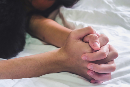 Hands of couple lover  on the bed,Concept about love, sex and lifestyle.の写真素材