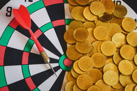 Red arrow dart board on Gold coin money for business success concept.の写真素材