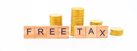 Free Tax word on wooden blocks and coins on white background.の写真素材