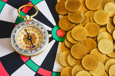 Compass and gold coin money for business financial concept.の写真素材