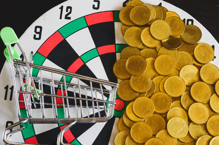 Gold coin money out of shopping trolleyの写真素材