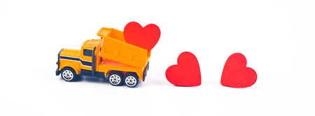 Truck car carry a red hearts sign on white background.Valentine day concept.の写真素材