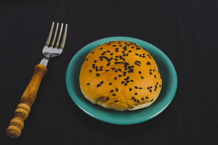 Bread with black sesame seeds in dish ware on background.の写真素材