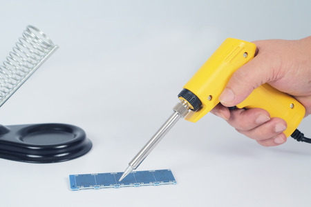 Soldering iron electronic work tool on background.の写真素材