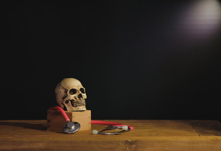 Still life painting photography with human skull on text book.