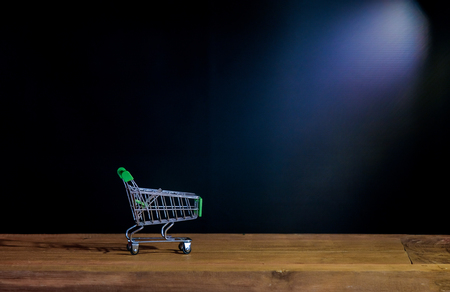Still life small shopping cart on wood table .の写真素材