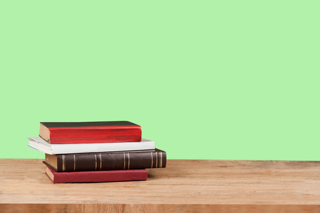 Old text books on grunge wood table with color background.の写真素材