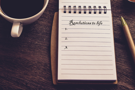 Resolutions to life text on book note with cup of coffee, pen and 


smartphone.の写真素材