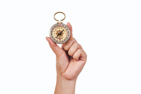 Old Vintage compass in hand for travel navigation .