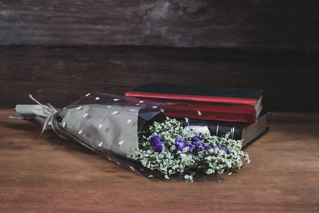 Still life text Book with Flower bouquet on wood table background.の写真素材