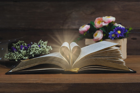 Still life Heart sign on text book on wood table background.の写真素材