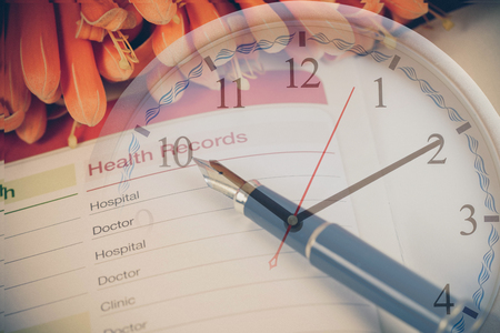 Health records in book note with fountain pen in clockの写真素材