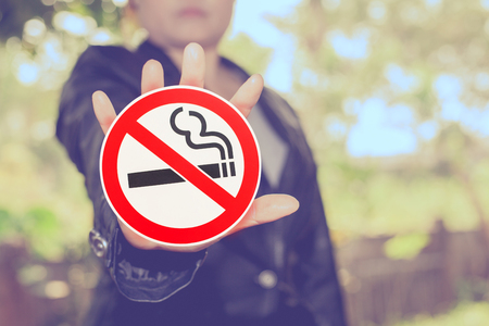 No smoking sign in hand on color background ,health concept.の写真素材