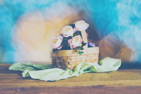 Still life with pink roses in basket on the table .の写真素材
