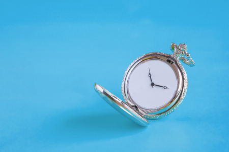 Vintage pocket watch on color background.