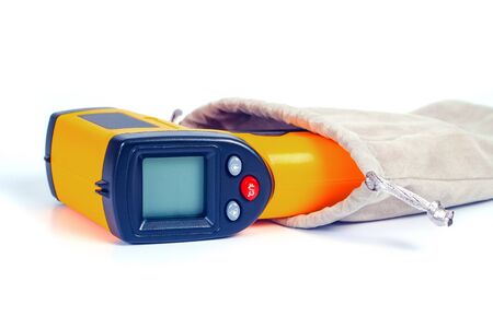 Yellow Infrared thermometer gun used to measure temperature  on white background.の写真素材