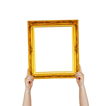 Hand hold vintage color golden picture frame on white background.