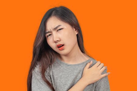 woman suffers from shoulder pain, health concept.の写真素材