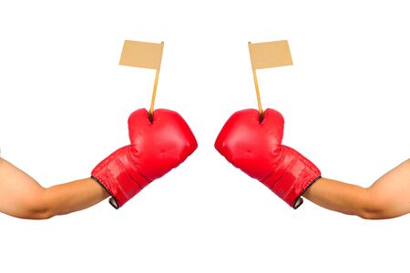 Red leather boxing gloves hold a small flag on white.の写真素材