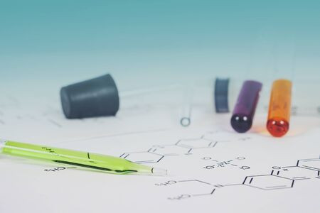 Laboratory test tube with dropper and chemical formula background , science concept.の写真素材