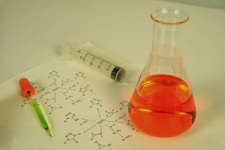 Laboratory test tube with dropper and chemical formula background , science concept.の写真素材