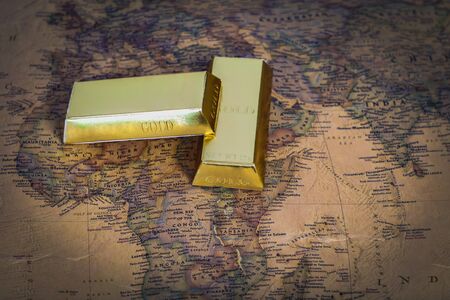 Golden bar on vintage map on background.の写真素材