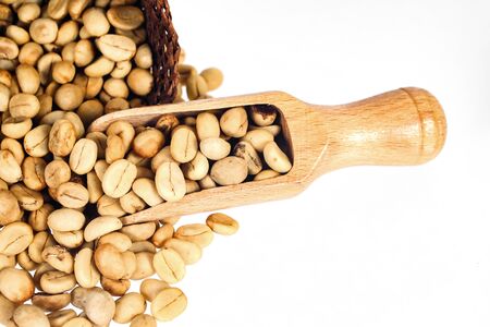 Fresh Raw coffee beans in wood spoon on background.の写真素材