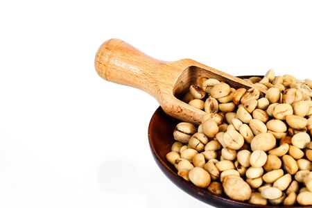 Fresh Raw coffee beans in wood dish on white background.の写真素材