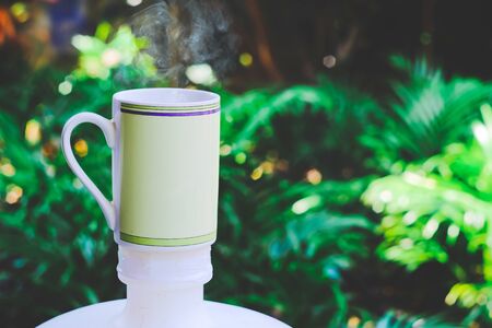 Hot coffee cup in backyard background.の写真素材