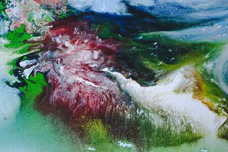 Abstract Oil color paint splatter on ground.