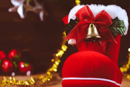 Red boot christmas or Santa's shoe on rustic wooden table,Christmas background.の写真素材