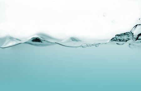 Water splash or water wave with bubbles of air on the background.