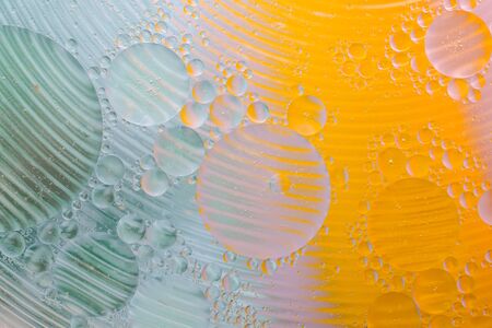 Oil drop on water with colerful to creation design background.