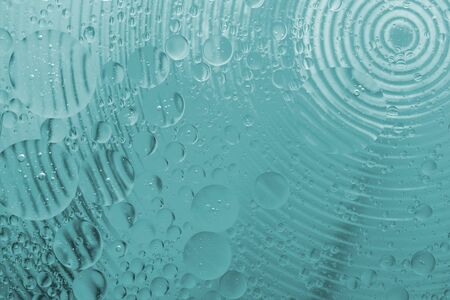 Oil drop on water with colerful to creation design background.