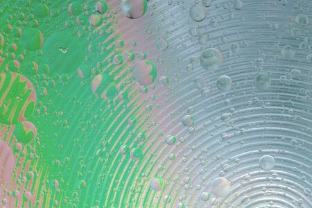 Oil drop on water with colerful to creation design background.