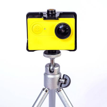 Action camera on mini tripod with white background.の写真素材