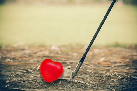 Play golf with red heart ball valentine day conceptの写真素材