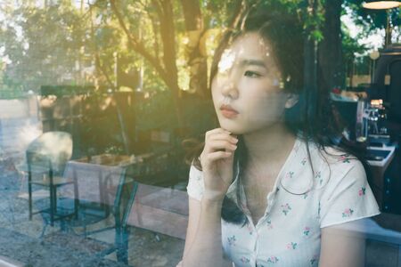 Double Exposure of woman in coffee shop and forest ,Lifestyle conceptual background.の写真素材