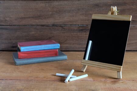 Mini blackboard on standing with white chalk on work desk .の写真素材