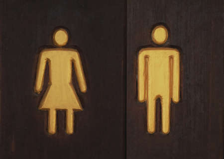 Icon man and woman signs on wood plate.