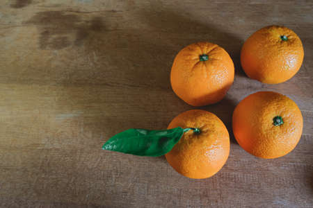 Fresh sweet orange fruit on old wood top table .