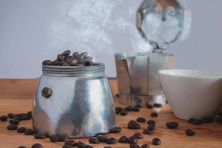 Fresh coffee bean in moka pot coffee maker on table.の写真素材
