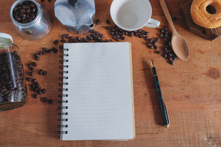 Booknote and pen on tabe with fresh coffee maker set .の写真素材
