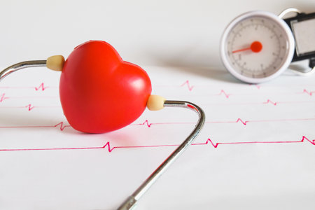 Stethoscope with red heart ball on paper heart sign wave.の写真素材