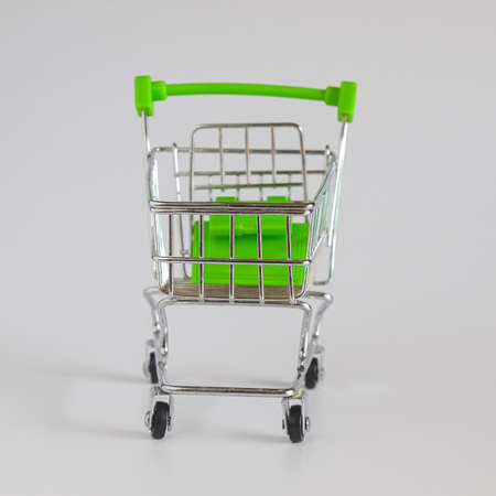 Green Supermarket shopping cart on white.の写真素材