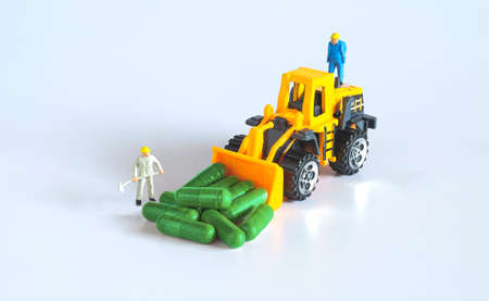 Worker figure with herb drug capsule ,health concept.